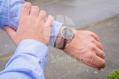 Business men looking at watch - Stock Media Bay